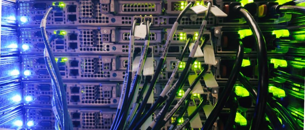 A rack of servers lit by bright LED status lights.